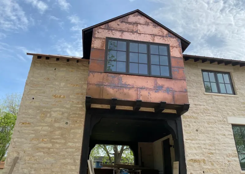 Copper metal panel facade on a stone building for Roof Repair in Cresskill