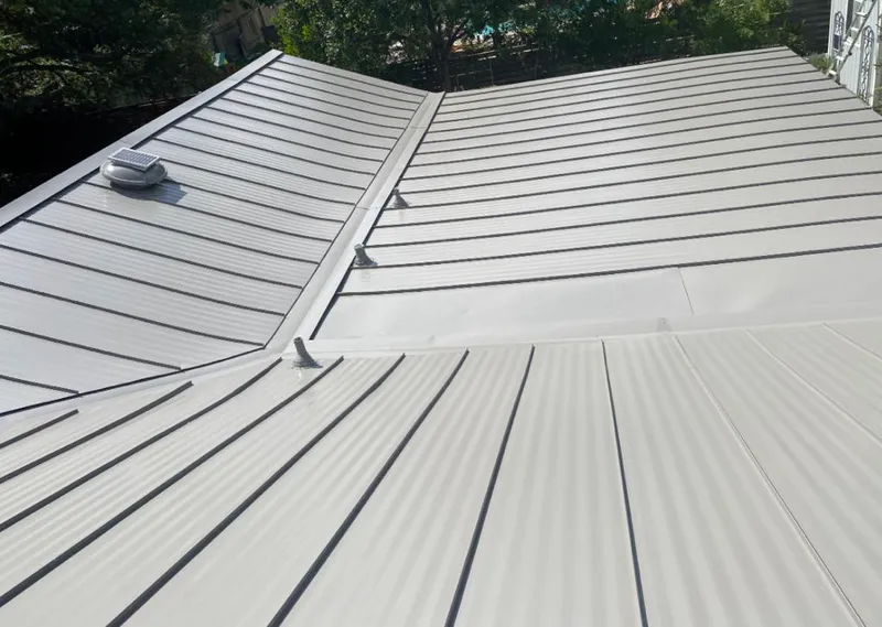 Solar attic fan installed on a metal roof for Roof Ventilation in Cresskill