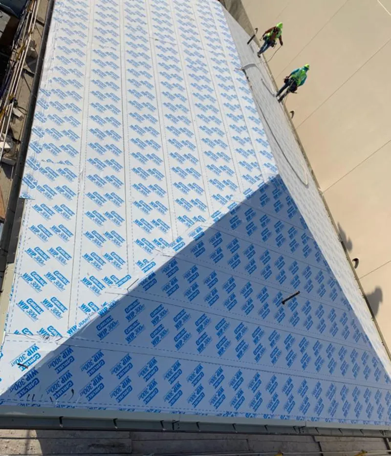 Professional roofers installing underlayment on a metal roof in Cresskill